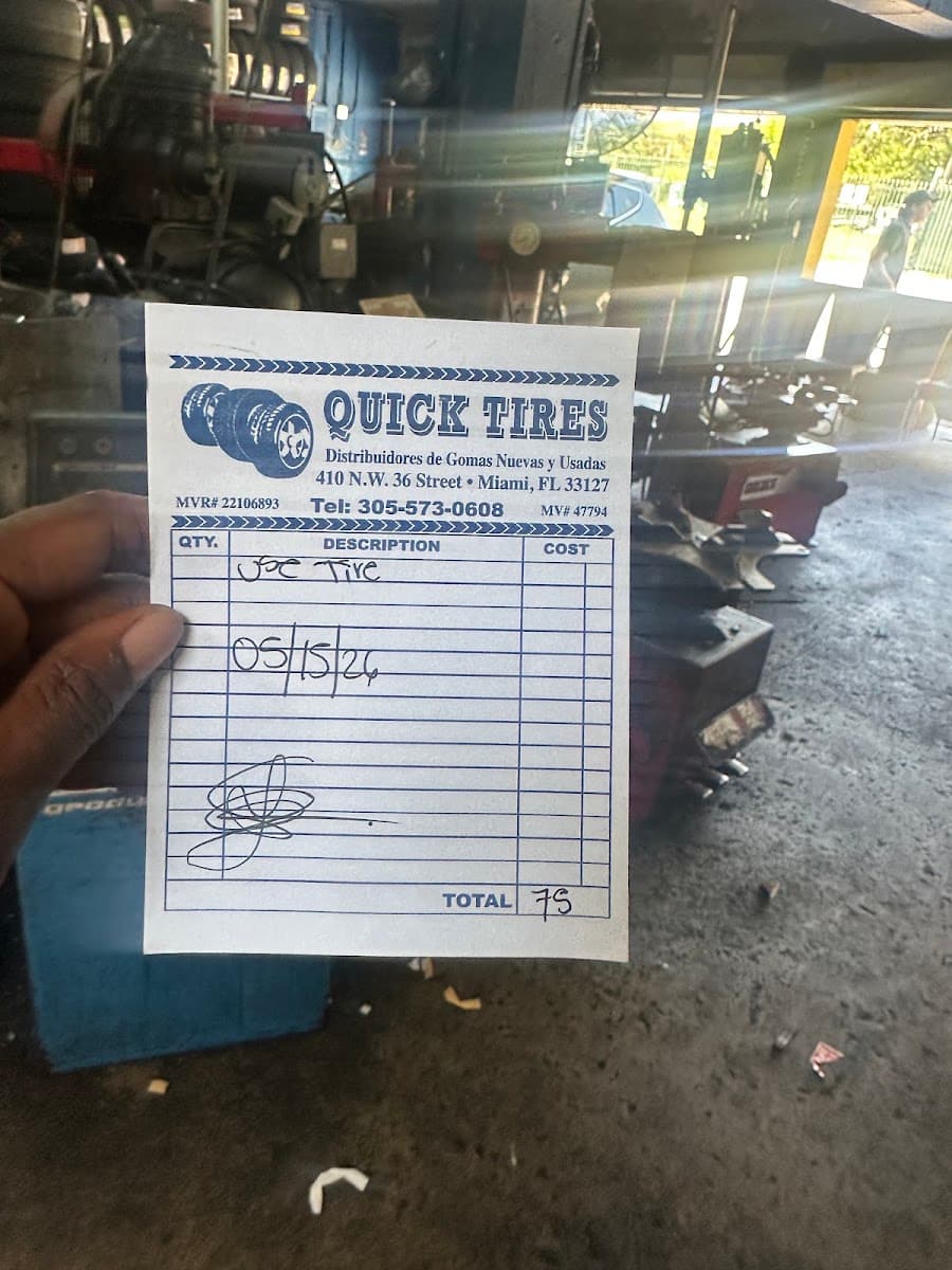 A real handwritten Quick Tire repair receipt